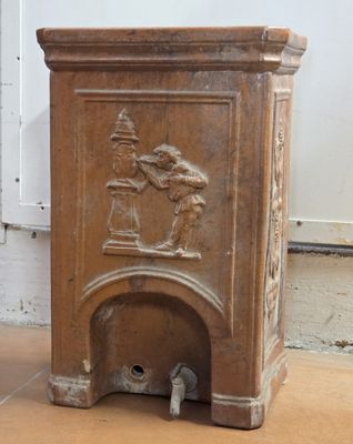 a small fire place with a statue on top of it