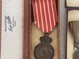 two medals are in a box with a ribbon and a medal