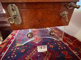 a close up of a table with a glass top and a rug on it