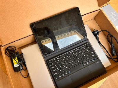 a laptop computer sitting in a box on the floor