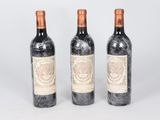three bottles of wine sitting next to each other on top of a table
