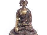 statue d'un Bouddha assis sur un socle, sur fond blanc