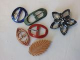 four different types of brooches on a white surface