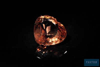 a large orange diamond on a black surface