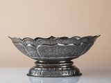 an image of a silver bowl sitting on top of a table