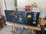 an image of a large printer sitting on top of a wooden table