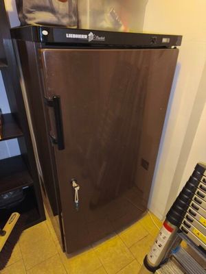 an image of a refrigerator in the corner of a room
