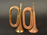 pair of antique brass trumpets on black background