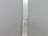 a knife that is sitting on top of a plate