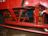an image of a red tractor with a big wheel