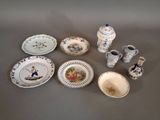 many plates and vases that are sitting on a table