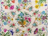 an image of a white table cloth with colorful flowers on it