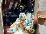 a cardboard box filled with assorted items sitting on the floor