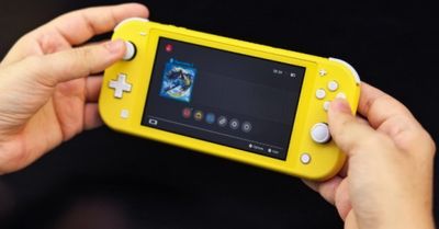 someone is holding a yellow nintendo wii game system in their hands
