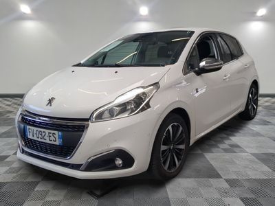 la voiture blanche est garée sur un sol en damier dans le garage