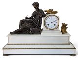 a statue of a woman sitting on top of a table with a clock