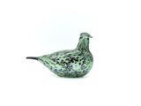 a glass bird that is sitting on a white surface