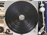 a record player sitting in a suitcase with a record in it