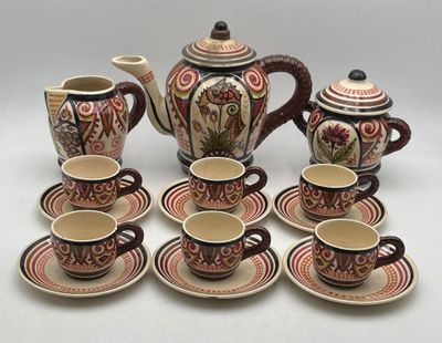 a group of coffee cups and saucers on a table