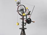 an image of a sculpture of a spinning machine with yellow balls