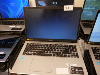 several laptops are sitting on a table with price tags on them