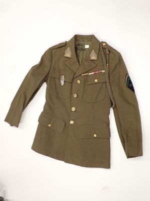 an image of a military jacket on a hanger on a wall