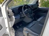 the interior of a car with the door open and the driver ' s seat down