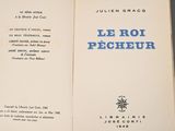 an open book with blue writing on it sitting on a table