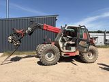 a tractor that is parked in front of a building