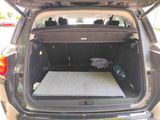 a mattress in the back of a car with the door open