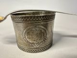 a silver cup with a spoon in it and a spoon sticking out of it