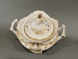 a white bowl with a gold decoration on it