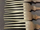 several forks are lined up in a row on a table