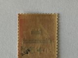 an old stamp with a bird on it on a white surface