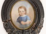 portrait of a young girl in a blue dress in a black frame