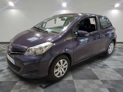 a picture of a purple toyota yaris parked in a garage