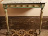 a marble top table with gold legs and a marble top