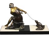 bronze statue of a man with a dog on a leash
