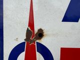 a red, white, and blue sign with a bird on it