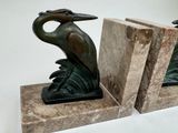 two bookends with a bird on top of them