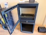 a small oven that is open and sitting on the floor