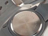 a close up of a watch on a white surface