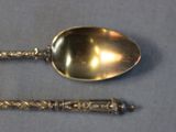 two spoons and a spoon with a handle on a table