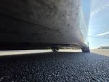 a close up of a car ' s tire on the road