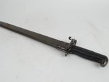 a close up of a knife on a table with a white background