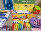 a lot of school supplies that are on the table