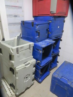 several blue and white boxes stacked on top of each other in a room