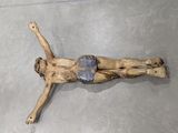 a wooden sculpture of a man laying on the ground