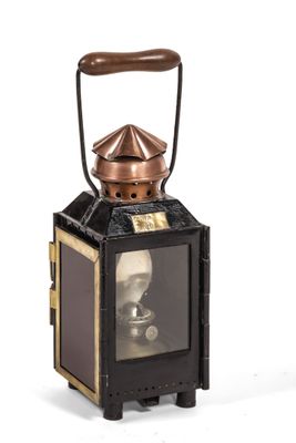 a black and gold lantern with a picture of a man on it