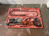 a tool in a red case on the floor